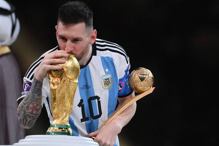 Lionel Messi beija o troféu de campeão da Copa depois de receber o prêmio de craque do torneio.