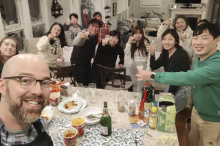 An undated photo provided by Alexander Campagna shows Alexander Campagna, a dentist, and his wife, Andrea, a nurse practitioner, hosting 10 stranded South Korean visitors who were in a tour group headed to Niagara Falls.(Alexander Campagna via The New York Times)