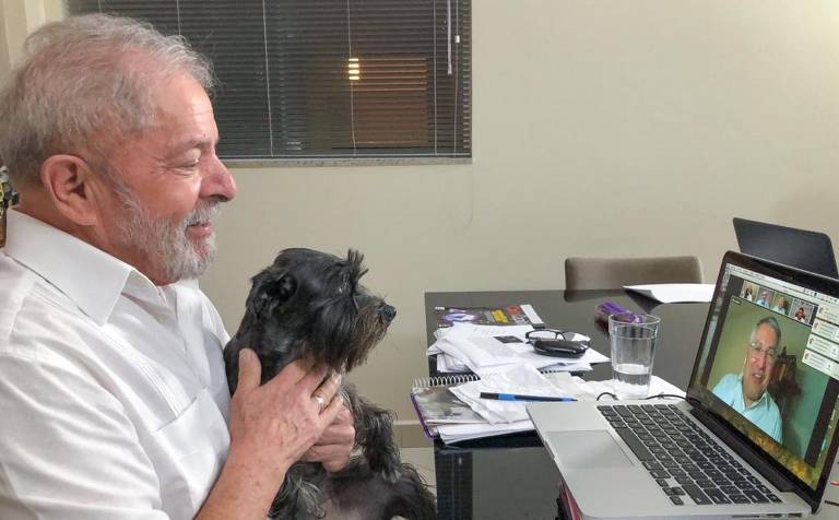 Lula com a cadela Resistência em seu colo durante reunião de trabalho, em foto postada no perfil do petista