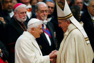 FILE PHOTO: Pope Francis greets Pope Emeritus Benedict XVI during a mass to create 20 new cardinals during a ceremony in St. Peter's Basilica at the Vatican