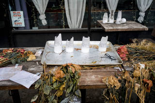 A memorial for the four University of Idaho students who were found stabbed to death in a home near the campus, in front of Mad Greek, a restaurant in downtown Moscow, Idaho, Dec. 31, 2022. (Margaret Albaugh/The New York Times)
