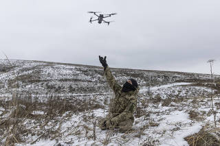 A member of a volunteer battalion practices the launch and retrieval of a DJI Mavic drone as the group trains outside Kyiv, Dec. 3, 2022. (David Guttenfelder/The New York Times)
