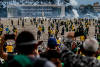 Supporters of Brazilian former President Jair Bolsonaro assist a Military Manifestantes ajudam um policial militar durante confronto