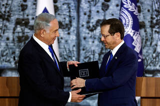 FILE PHOTO: Israel President Isaac Herzog hands Benjamin Netanyahu the mandate to form a new government following the election victory of the former premier's right-wing alliance