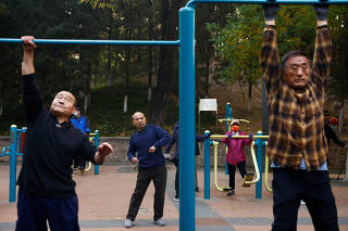 Elderly people exercise in the morning at a park in Beijing
