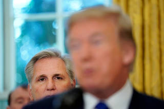FILE PHOTO: Rep. Kevin McCarthy (R-CA) looks at U.S. President Donald Trump as he delivers remarks about the situation of the jobs market in the Oval Office of the White House in Washington