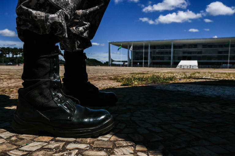 Em destaque, coturnos de um militar, e, ao fundo, o Palácio do Planalto