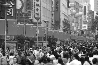 People throng the Nanjing Road shopping district in Shanghai