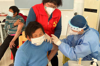 Coronavirus disease (COVID-19) vaccination to elderly people at a vaccination center on the outskirts of Shanghai