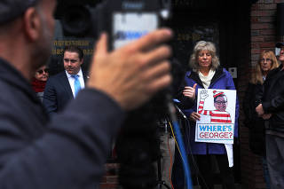 People demonstrate against newly elected freshman Rep. George Santos (R-NY) outside a future campaign office in in New York City