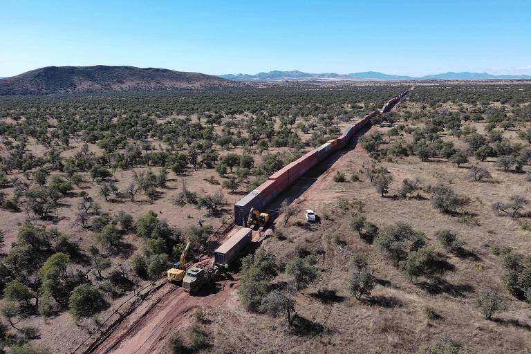 Trabalhadores removem muro de contêineres na fronteira do Arizona com o México