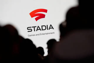 FILE PHOTO: Spectators look on during a Google keynote address announcing a new video gaming streaming service named Stadia at the Gaming Developers Conference in San Francisco