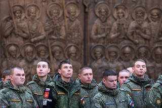 People attend a prayer at the Main Cathedral of the Russian Armed Forces near Moscow