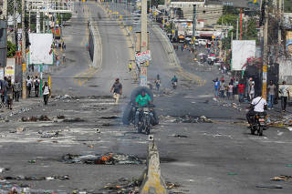 FILE PHOTO: Haitians protest over rising fuel prices during a nationwide strike, in Port-au-Prince