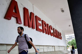 FILE PHOTO: People walk in front of a Lojas Americanas store in Brasilia