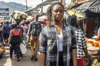 Eugenia Kargbo, Freetown's first chief heat officer, by newly installed market canopies at Congo Market in Freetown, Sierra Leone, Nov. 18, 2022.  (Yagazie Emezi/The New York Times)
