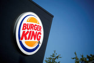 FILE PHOTO: The Burger King company logo stands on a sign outside a restaurant in Bretigny-sur-Orge, near Paris