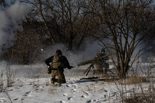 Soldiers from the Free Russia Legion fire against Russian positions a little more than a mile away along the front line in the Donbas region, in Eastern Ukraine, Feb. 3, 2023. (Lynsey Addario/ The New York Times)