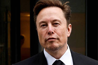 FILE PHOTO: FILE PHOTO: Tesla CEO Musk departs the company?s local office in Washington