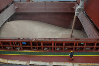 Crew member of Liberian-flagged bulk carrier Valsamitis watches for loading wheat for Kenya and Ethiopia in a sea port of the Chornomorsk town