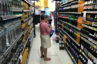 FILE PHOTO: A costumer looks for drinks at a supermarket in Rio de Janeiro