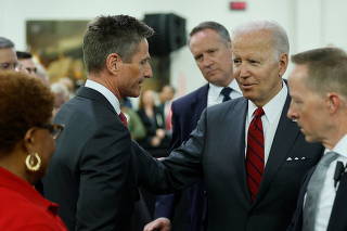U.S. President Biden speaks with Lockheed Martin CEO Taiclet at a Lockheed Martin weapons factory in Troy, Alabama