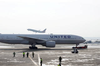 FILE PHOTO: A United Airlines Boeing 777 plane is towed at O'Hare International Airport in Chicago