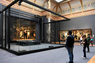FILE PHOTO: People look at Rembrandt's famed Night Watch at Rijksmuseum in Amsterdam