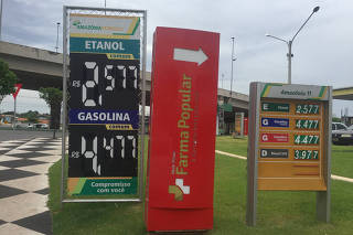FILE PHOTO: A placard shows prices for ethanol and gasoline at a gas station in Cuiaba