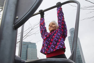 Diane Butts, a 60-year-old actor and model, hangs from a pull-up bar in New York, Feb. 26, 2023. (Nicholas Sansone/The New York Times)