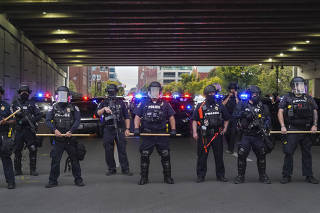 Police face off against protesters in the streets of Louisville, Ky., Thursday, Sept. 25, 2020, a day after a grand jury indicted a former Louisville police officer for wanton endangerment in the police shooting death of Breonna Taylor. (Chang W. Lee/The N