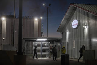 Young workers exit JBS pork plant after an overnight cleaning shift in Worthington, Minn. on Oct. 18, 2022. (Kirsten Luce/The New York Times)
