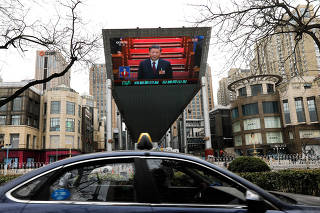 Giant screen displays a live broadcast of Chinese President Xi Jinping attending the closing ceremony of the National People?s Congress (NPC), in Beijing