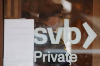 FILE PHOTO: A police officer controls access to a branch of Silicon Valley Bank in Wellesley