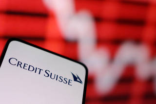 Illustration shows Credit Suisse logo and decreasing stock graph