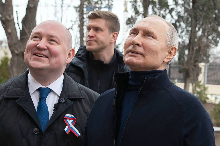 O presidente da Rússia, Vladimir Putin, conversa com o prefeito de Sevastopol,  Mikhail Razvozhayev, em visita à Crimeia em 18 de março de 2023. 

 