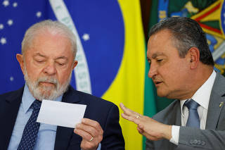 Brazil's President Luiz Inacio Lula da Silva talks with Chief of Staff of the Presidency Rui Costa during a ceremony at the Planalto Palace in Brasilia