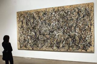 JACKSON POLLOCK PAINTING AT THE OPENING OF THE MUSEUM OF MODERN ART IN QUEENS
