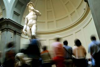 Visitors to the Accademia museum stop to get a closer look at Michelangelo's statue of David