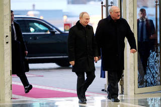 FILE PHOTO: Russian President Vladimir Putin and Belarusian President Alexander Lukashenko arrive for meeting in Minsk