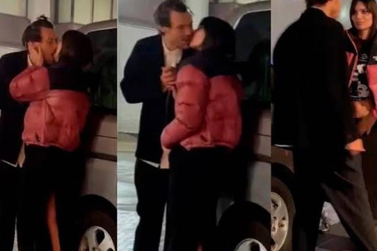 Harry Styles e Emily Ratajkowski se beijam encostados num carro, no meio da rua