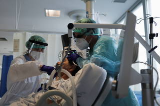 Health staff attend to a patient at the coronavirus disease (COVID-19) dedicated ICU unit of the Tras-Os-Montes E Alto Douro Hospital, in Vila Real