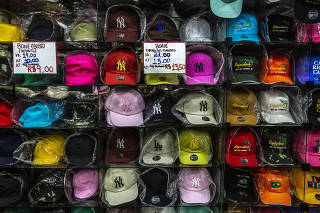 A large selection of counterfeit Yankees caps on display at a stand in Rio de Janeiro, on March 15, 2023. (Dado Galdieri /The New York Times)