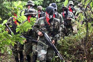 COLOMBIAN REBELS WALK IN THE JUNGLE CAMP IN ANTIOQUIA MOUNTAINS