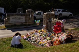FILE PHOTO: People visit a memorial after deadly shooting at the Covenant School in Nashville