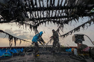 Seaweed farmers harvest seaweed near Soando Island, South Korea, on March 25, 2022. (Chang W. Lee/The New York Times)