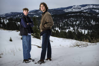 Badge, left, and Lander Busse, teenage plaintiffs in a lawsuit against the state of Montana saying it violated the state constitution that guarantees Òthe right to a clean and healthful environment,Ó near their home in Kalispell, Mont. on March 6, 2023. (Matthew Hamon/The New York Times)