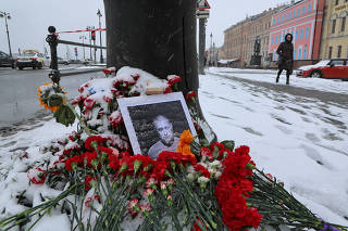 A portrait of Russian military blogger Vladlen Tatarsky, who was killed in the cafe explosion the day before, is placed near the blast site in Saint Petersburg
