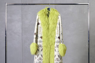 A green-fur-trimmed coat from Marina Moscone?s resort 2022 line is stored at a Garde Robe by Uovo storage facility in Brooklyn, Jan. 13, 2023. (Peter Garritano/The New York Times)