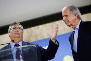 Brazilian justice minister nominee Flavio Dino speaks next to Brazilian defense minister nominee Jose Mucio Monteiro, during a news conference at the headquarters of the Government of the Federal District in Brasilia